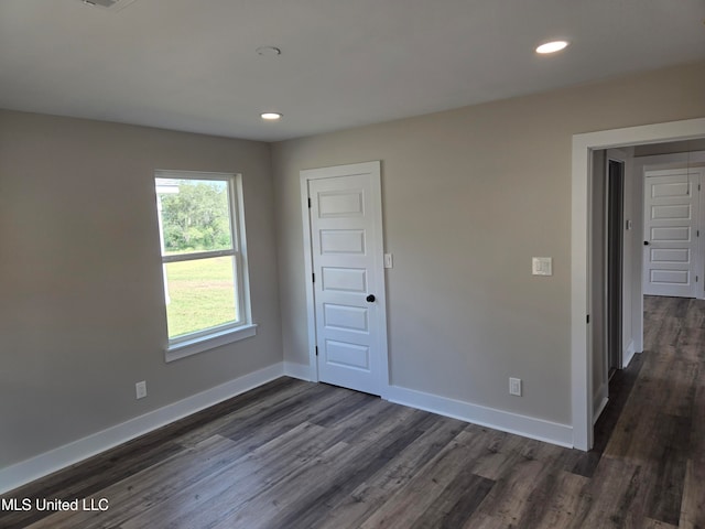 spare room featuring dark hardwood / wood-style flooring