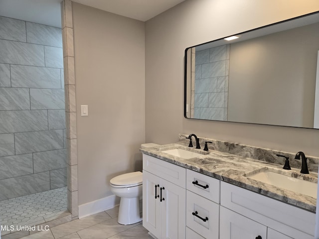 full bathroom with toilet, walk in shower, baseboards, double vanity, and marble look tiles