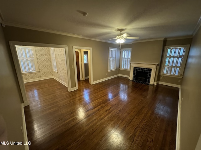 unfurnished living room with ornamental molding, dark wood-type flooring, a fireplace, and ceiling fan