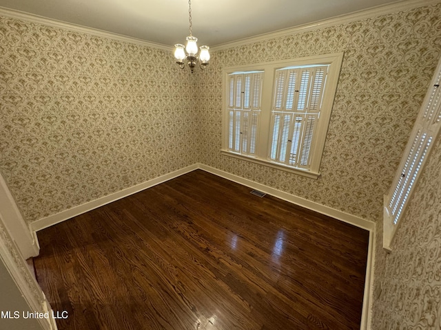 unfurnished dining area featuring ornamental molding, hardwood / wood-style flooring, and a chandelier