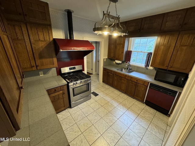 kitchen with black appliances, sink, a wood stove, hanging light fixtures, and a chandelier