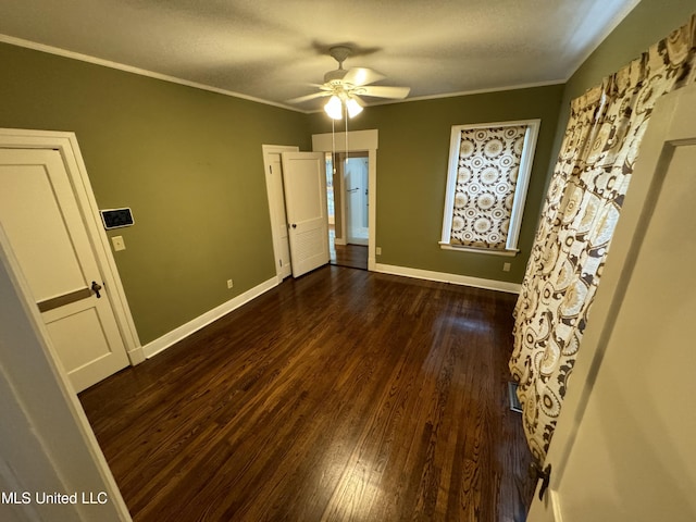 unfurnished bedroom featuring dark wood-type flooring, ceiling fan, crown molding, and a textured ceiling