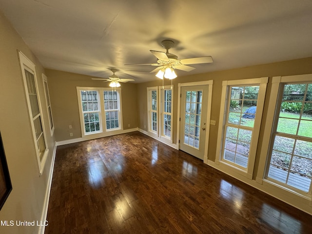 unfurnished room with dark hardwood / wood-style floors and ceiling fan