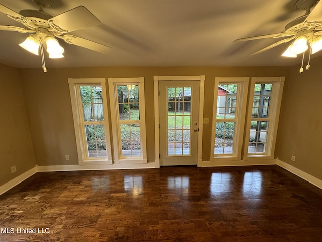 doorway to outside with dark wood-type flooring and ceiling fan