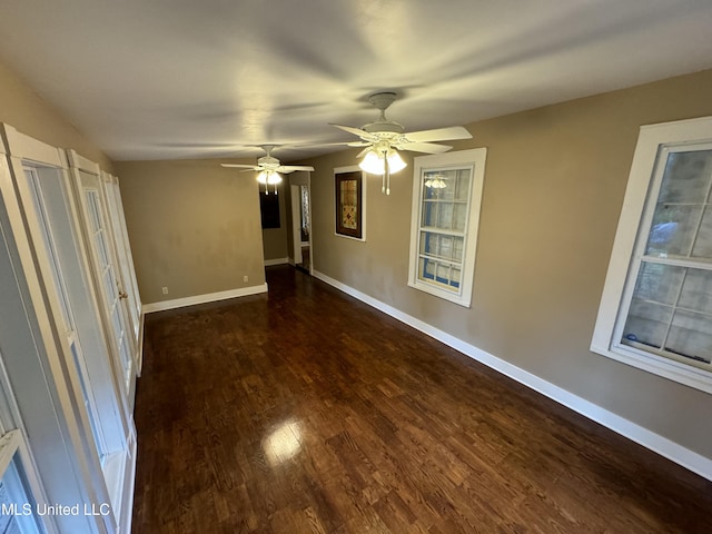 spare room with dark wood-type flooring and ceiling fan