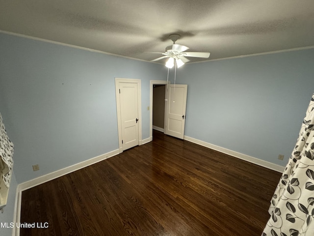 unfurnished bedroom with dark wood-type flooring, ceiling fan, ornamental molding, and a textured ceiling