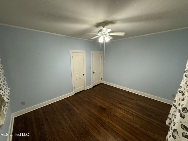 unfurnished bedroom with dark hardwood / wood-style flooring, ornamental molding, a textured ceiling, and ceiling fan