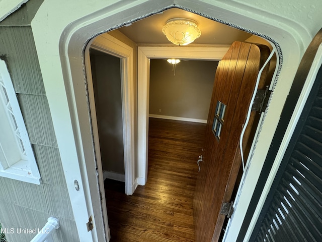 hallway with dark hardwood / wood-style flooring