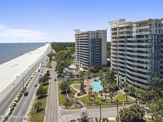 birds eye view of property featuring a water view and a beach view