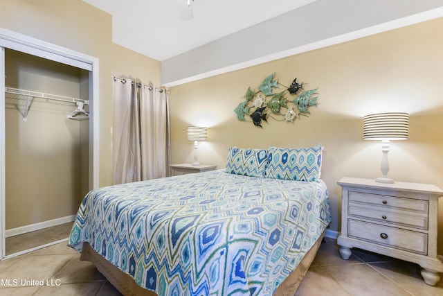 bedroom featuring tile patterned floors, a closet, and ceiling fan