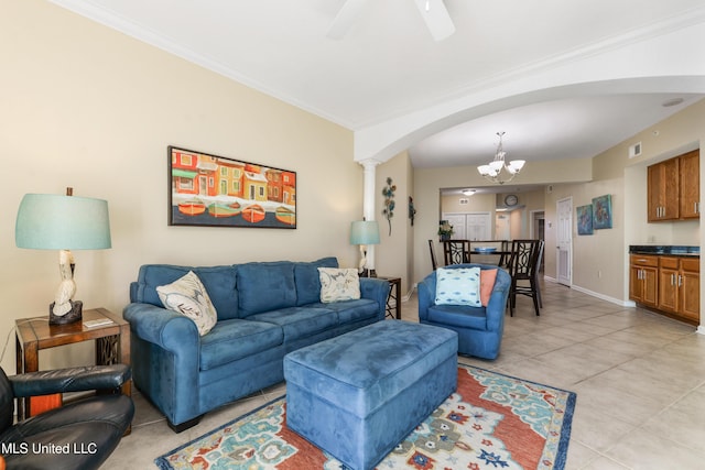 living room featuring ceiling fan with notable chandelier, ornamental molding, and light tile patterned floors