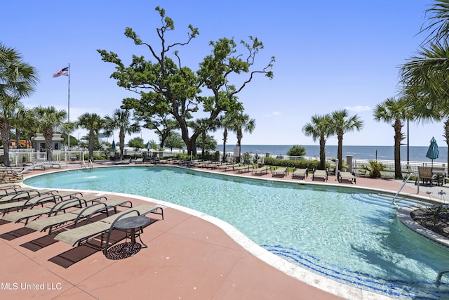 view of pool featuring pool water feature, a patio area, and a water view