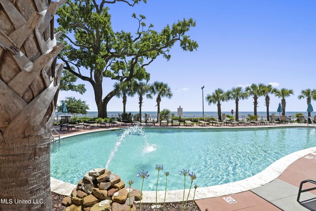 view of swimming pool with pool water feature