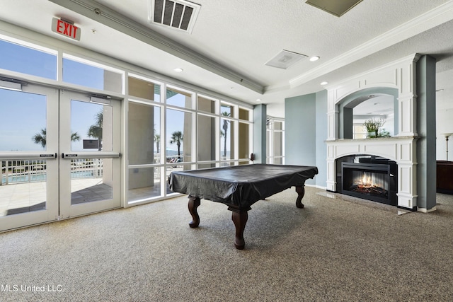 recreation room with carpet flooring, ornamental molding, a textured ceiling, a raised ceiling, and billiards