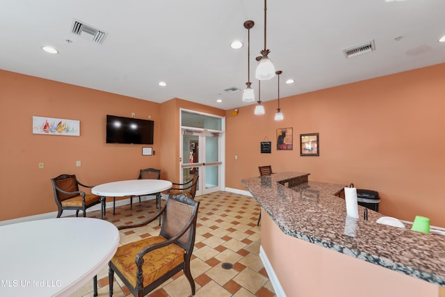 kitchen featuring decorative light fixtures and dark stone counters