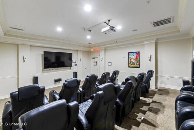 home theater room with carpet floors, a raised ceiling, and crown molding