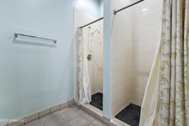 bathroom with tile patterned flooring and walk in shower