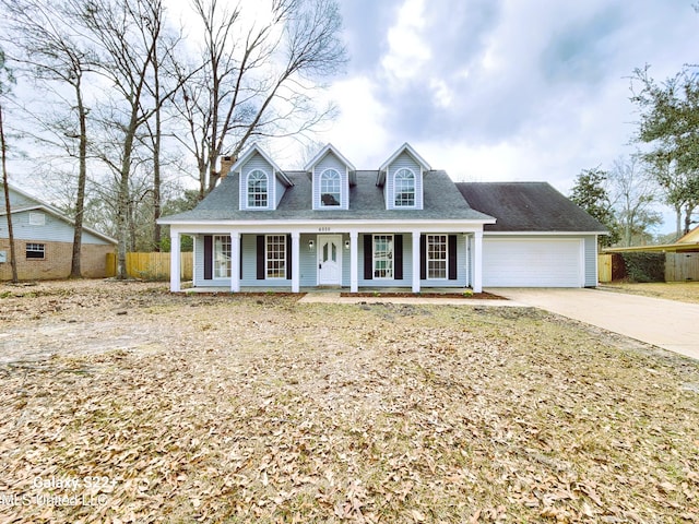 cape cod home featuring a porch and a garage