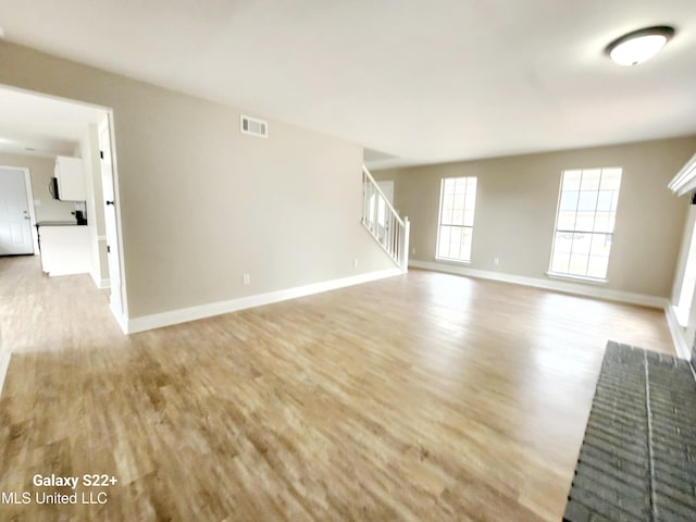 unfurnished living room with light hardwood / wood-style flooring