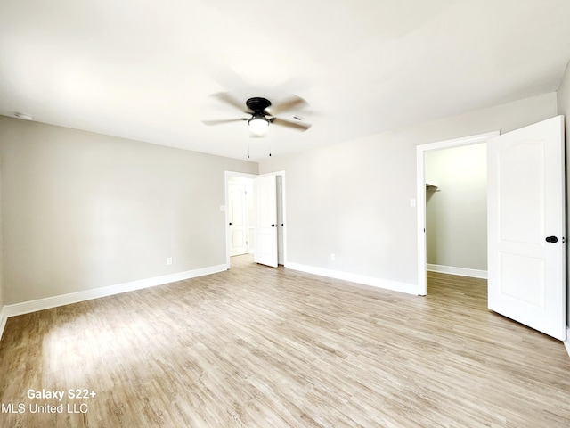 spare room featuring ceiling fan and light wood-type flooring