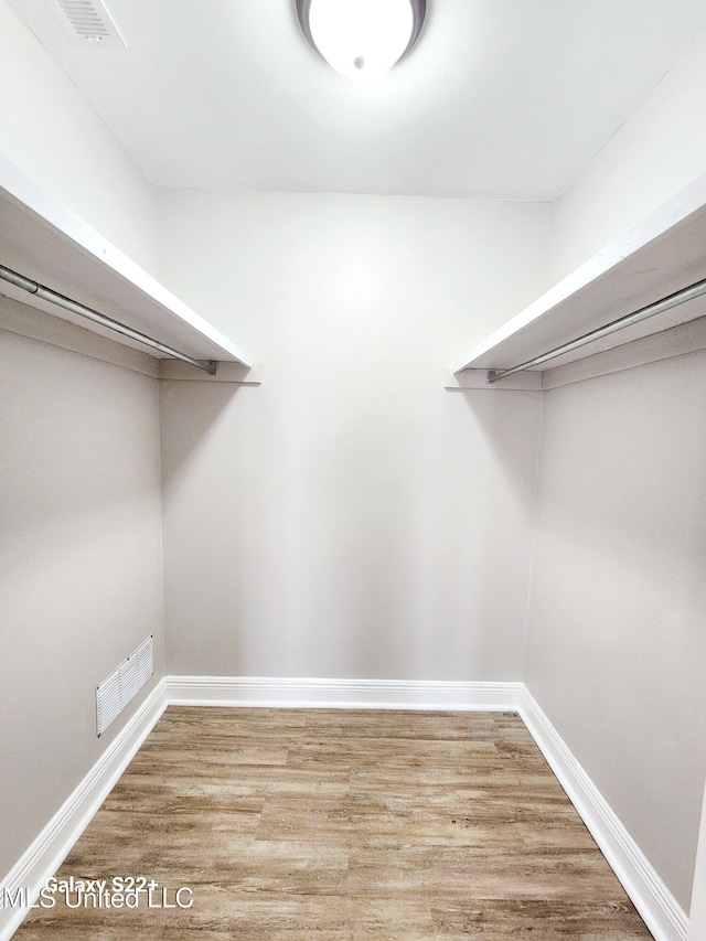 spacious closet with light hardwood / wood-style floors