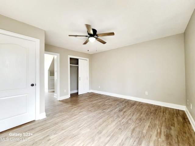 unfurnished bedroom with a closet, ceiling fan, and light hardwood / wood-style flooring