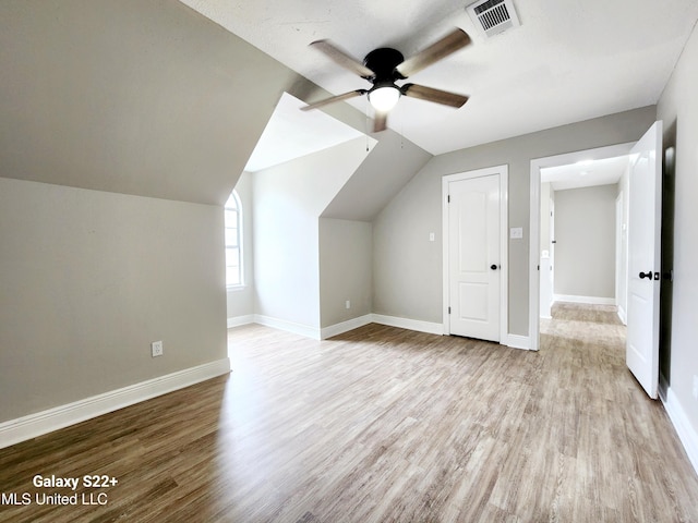 bonus room featuring ceiling fan, vaulted ceiling, and light wood-type flooring