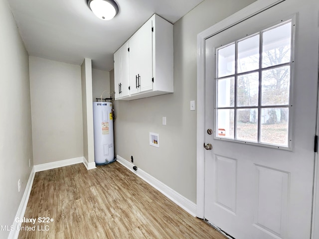 washroom with cabinets, light hardwood / wood-style floors, hookup for a washing machine, and water heater