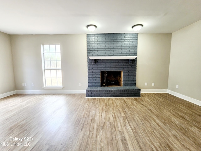 unfurnished living room with hardwood / wood-style flooring and a fireplace