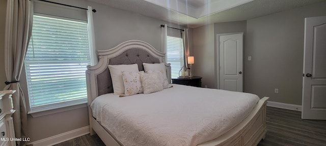 8422 Kaleki Way, Diamondhead, MS 39525 - bedroom featuring baseboards, dark wood finished floors, and multiple windows