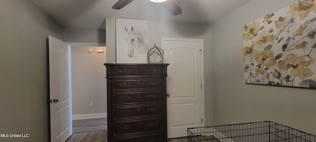8422 Kaleki Way, Diamondhead, MS 39525 - bedroom featuring wood finished floors, a textured ceiling, baseboards, and ceiling fan