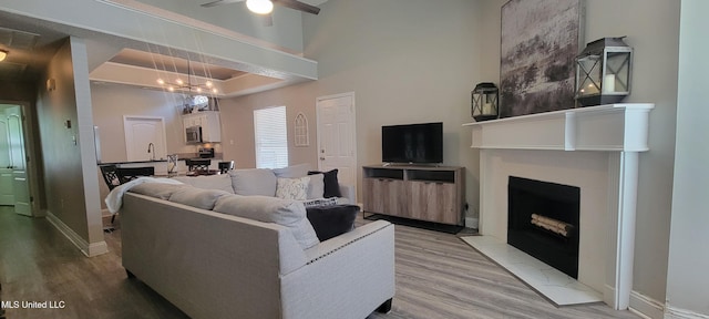 8422 Kaleki Way, Diamondhead, MS 39525 - living area with a fireplace with flush hearth, light wood-style floors, a ceiling fan, and baseboards