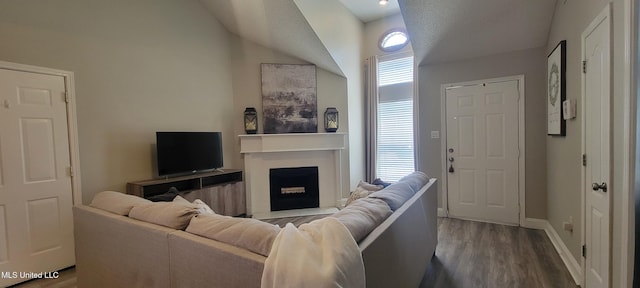 8422 Kaleki Way, Diamondhead, MS 39525 - living area with vaulted ceiling, wood finished floors, a fireplace, and baseboards
