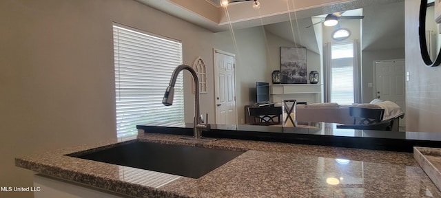 8422 Kaleki Way, Diamondhead, MS 39525 - kitchen with a sink, dark stone counters, and a ceiling fan