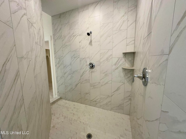 bathroom with a tile shower