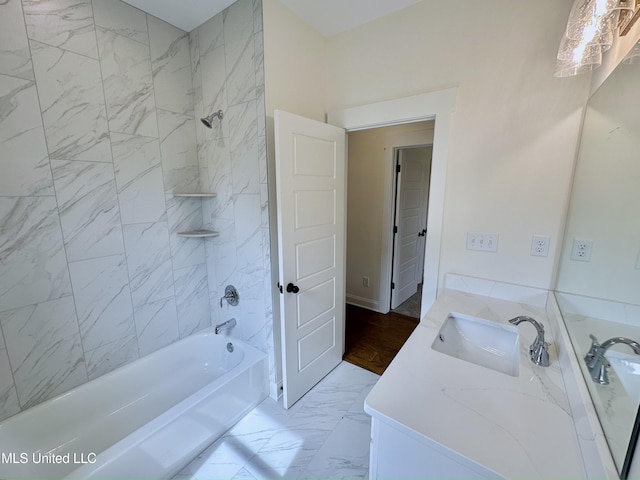 bathroom with tiled shower / bath and vanity