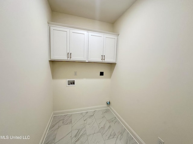 laundry room with washer hookup and cabinets