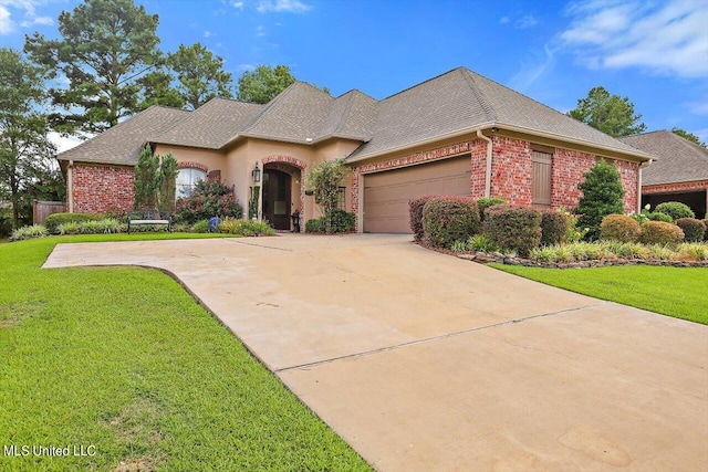 view of front of home with a garage and a front lawn