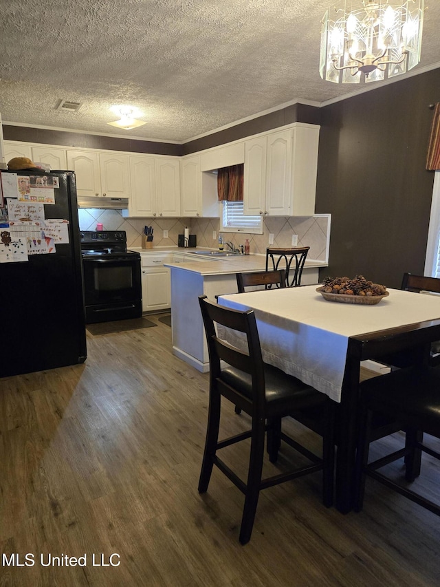 dining area with dark wood-style floors, a chandelier, a textured ceiling, and crown molding