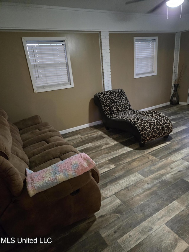sitting room featuring wood finished floors, baseboards, plenty of natural light, a ceiling fan, and ornamental molding