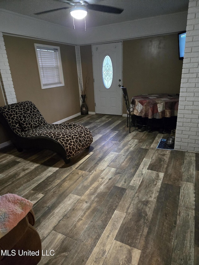 entryway with wood-type flooring, ceiling fan, and baseboards