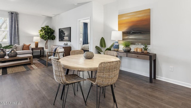 dining room with dark hardwood / wood-style flooring