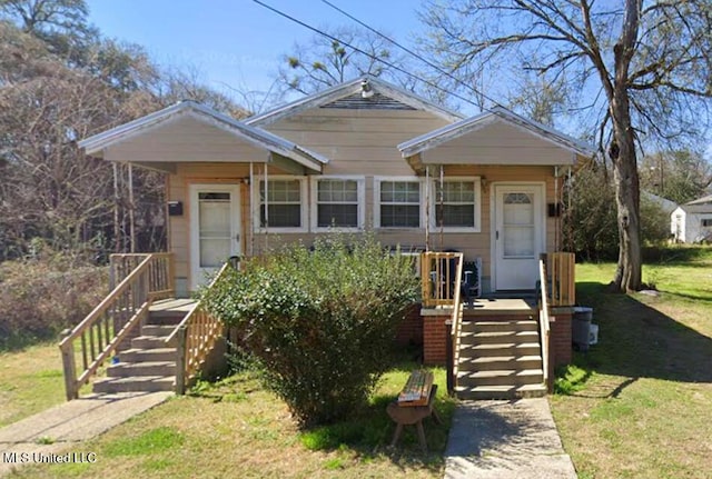 bungalow-style house with a front lawn