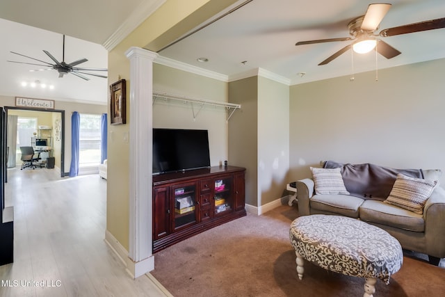 8412 Kaleki Pl, Diamondhead, MS 39525 - living room featuring ceiling fan, baseboards, decorative columns, and ornamental molding