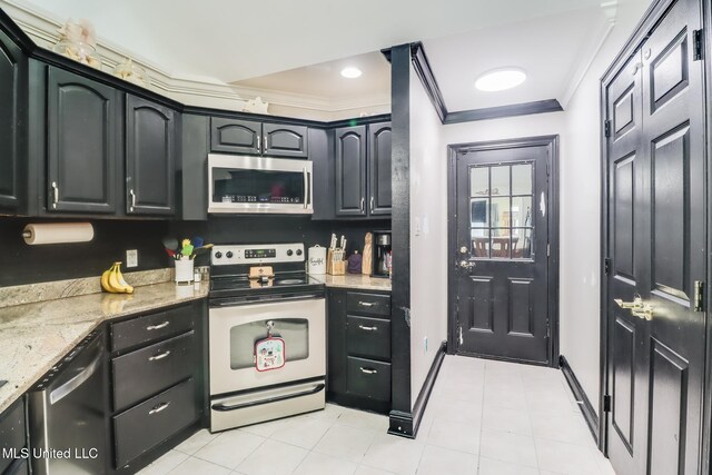 8412 Kaleki Pl, Diamondhead, MS 39525 - kitchen featuring appliances with stainless steel finishes, crown molding, light stone countertops, baseboards, and light tile patterned floors