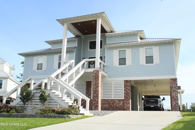 13152 Hanover Dr, Ocean Springs, MS 39564 - beach home with a carport, brick siding, stairs, driveway, and a metal roof
