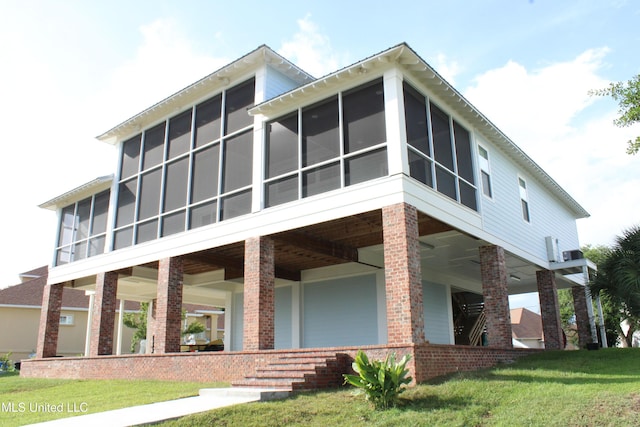13152 Hanover Dr, Ocean Springs, MS 39564 - view of front of house featuring a sunroom and a front yard