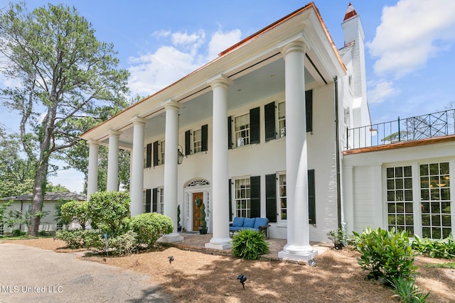 neoclassical / greek revival house featuring a balcony