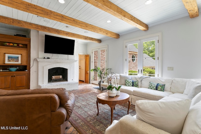 living room with beam ceiling and a fireplace