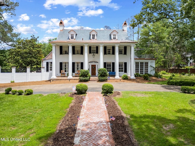 view of front of home with covered porch and a front yard